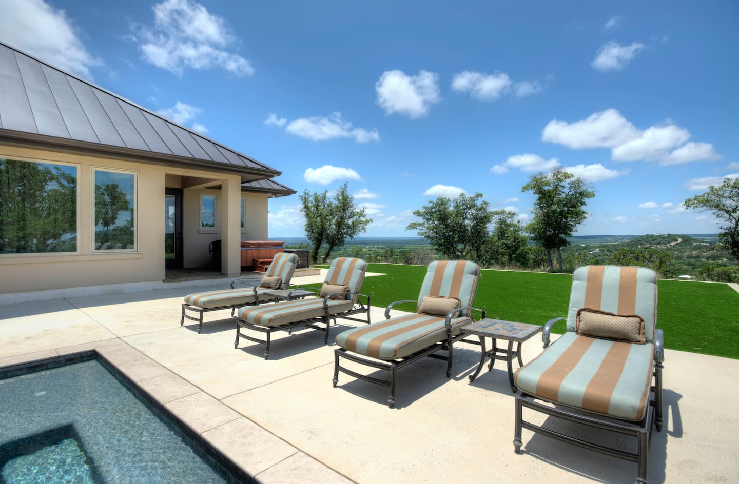 Poolside loungers and the open Hill Country view