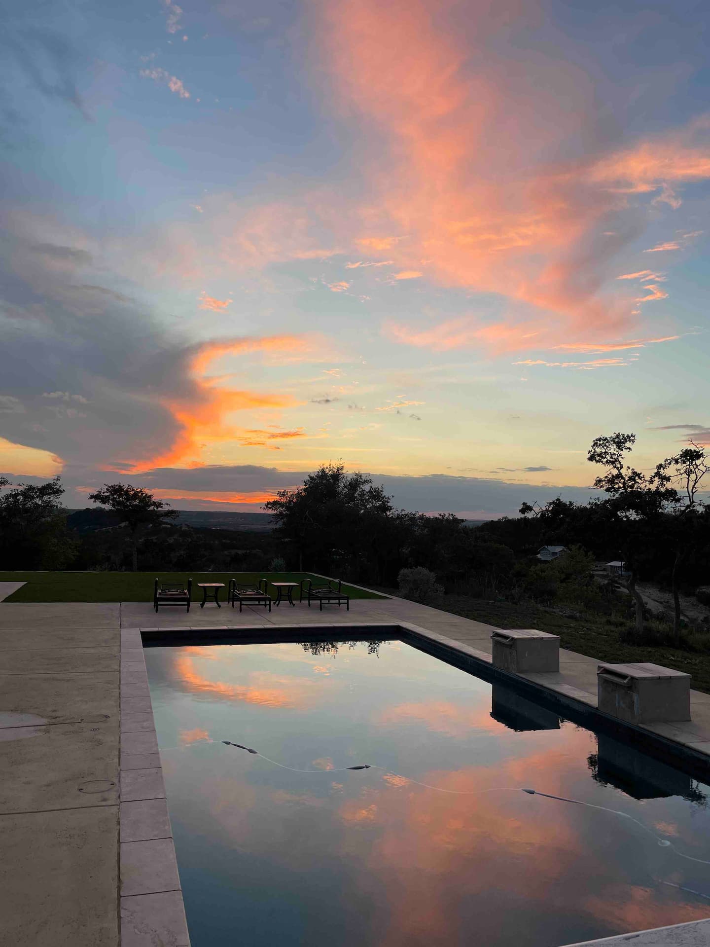 Orange sunset beyond the Hill House pool